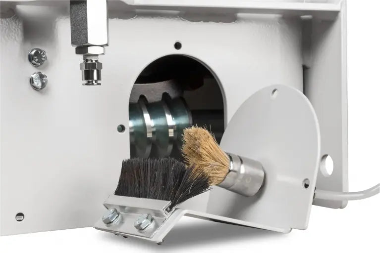 Close-up of a special flexible adaptor to absorb the use and the released vibrations of the cordless drill with a brush inside a white casing.